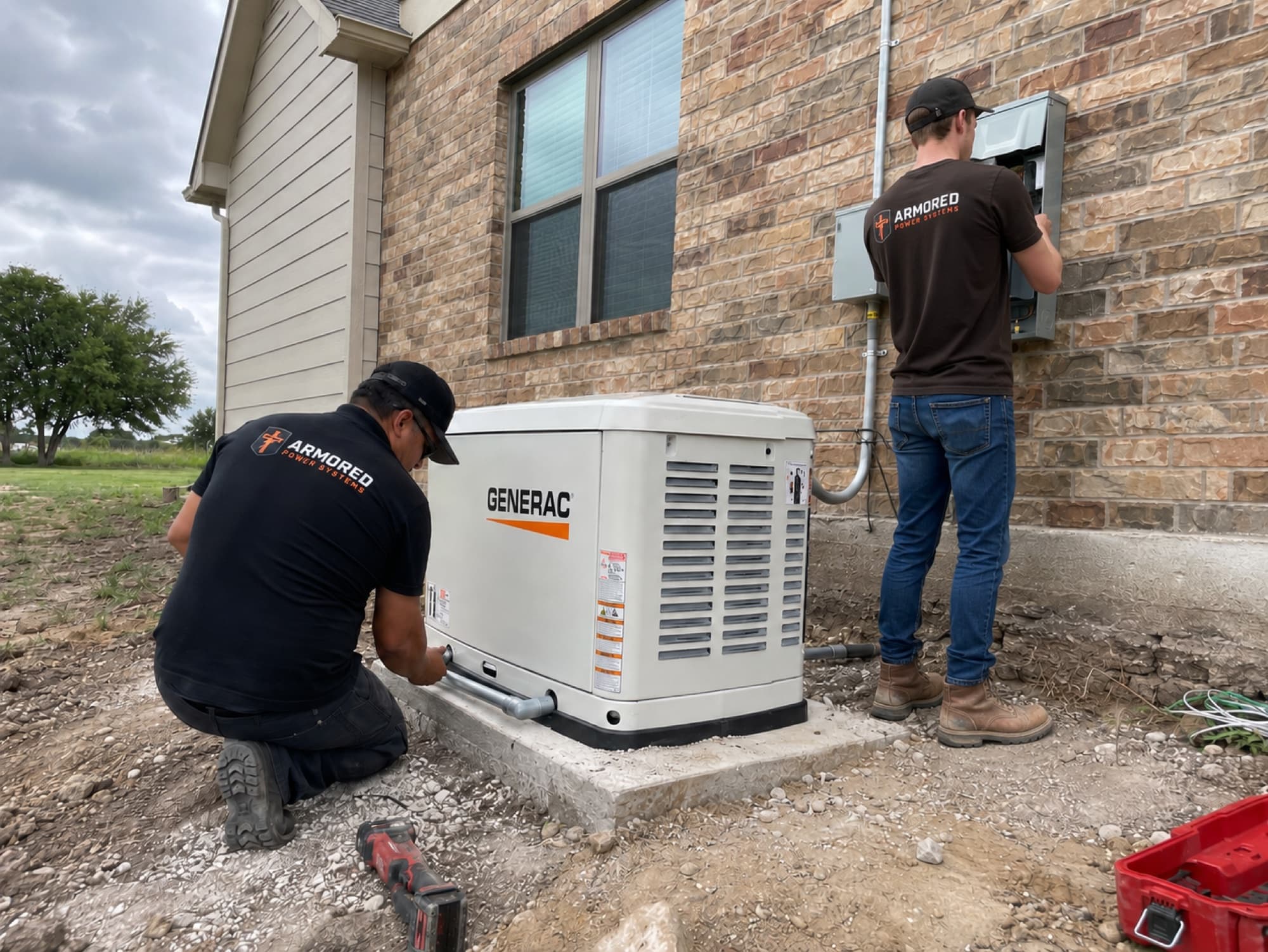 Armored Power Systems technicians setting a Generac home standby generator on a concrete pad beside a brick Texas home under a storm sky.